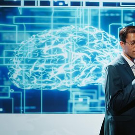 Journée de sensibilisation Homme faisant une présentation, cerveau projeté derrière lui sur un écran
